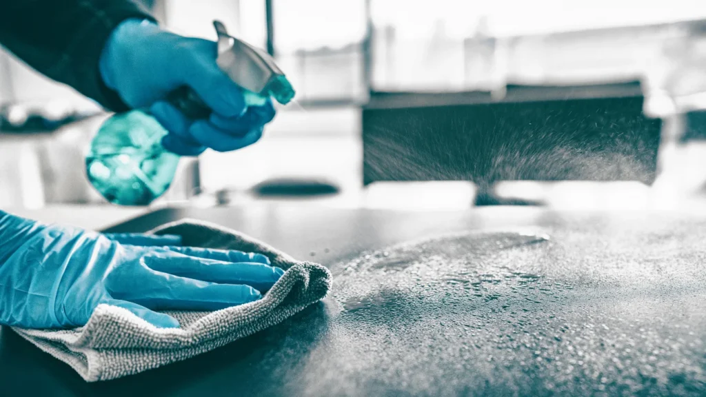 Cleaning a desk during a commercial cleaning job in Downtown San Diego